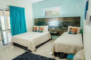 Deluxe Triple Room with kitchen | Down comforters, in-room safe, laptop workspace, blackout drapes