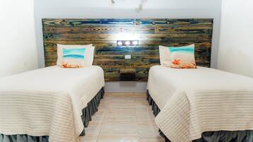 Suite Deluxe, 2 habitaciones, vista a la alberca | Edredón y caja de seguridad en la habitación