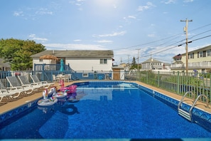 Seasonal outdoor pool, open 9:00 AM to 8:00 PM, pool umbrellas