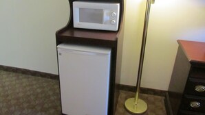 A compact kitchenette with a microwave and a mini-fridge. - Executive Inn and suites, independent hotel (Wichita Falls)