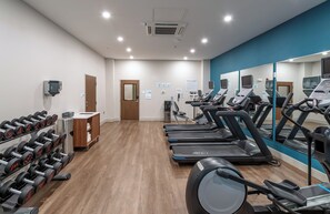 A fitness center with treadmills, dumbbells, and a mirror wall. - Holiday Inn Express & Suites Columbus - Worthington by IHG (Columbus)