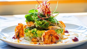 A plate of food with various ingredients and garnishes.