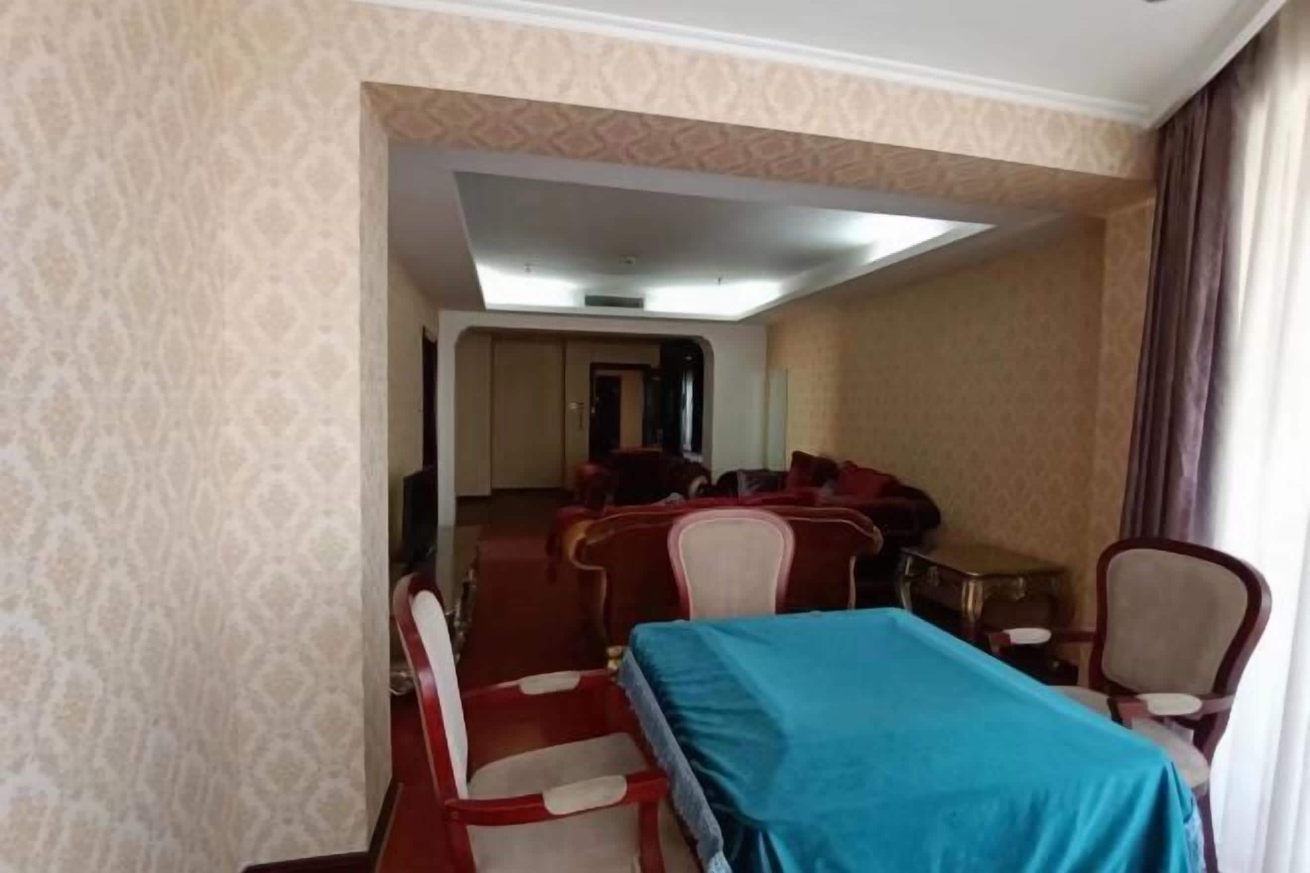 A hotel room with a bed, a desk, and a chair.