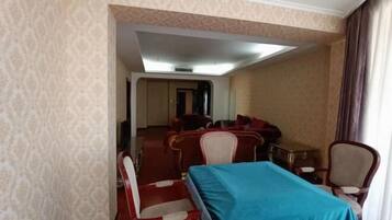 A hotel room with a bed, a desk, and a chair.