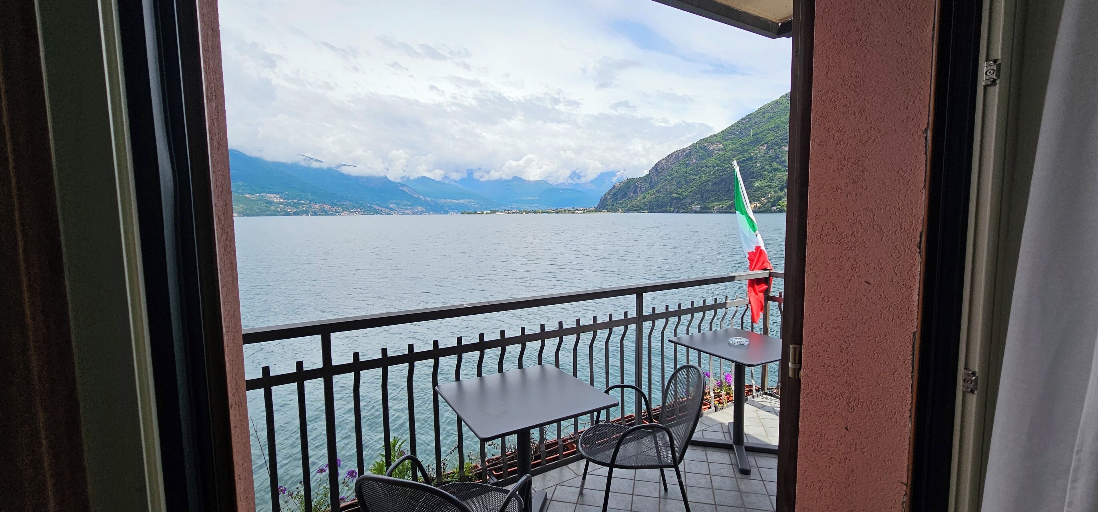 A balcony with a view of a lake and mountains.