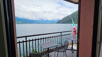 A balcony with a view of a lake and mountains.