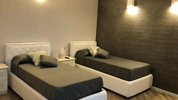 Family Quadruple Room, Courtyard View | Down comforters, in-room safe, desk, blackout drapes