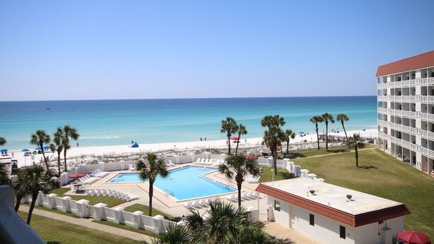 A hotel with a pool, beach view, and palm trees. - El Matador 358 -  FREE TICKETS!! Your stay includes free tickets to many area attractions! (Fort Walton Beach)