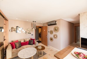 A modern living room with a sofa, coffee table, and decorative mirrors. - AVENUE SUITES APPART HOTEL - STANDARD (Maarif)