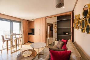 A modern living room with a sofa, coffee table, and dining area. - AVENUE SUITES APPART HOTEL - STANDARD (Maarif)