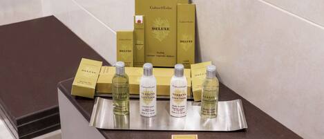 A display of Verbenna Lavender products including shampoo, conditioner, body lotion, and soap on a counter.