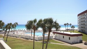 A hotel with a pool, palm trees, and a view of the beach. - El Matador 338 -  FREE TICKETS!! Your stay includes free tickets to many area attractions! (Fort Walton Beach)