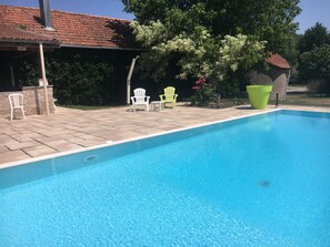 Seasonal outdoor pool, open 9:00 AM to noon, pool umbrellas
