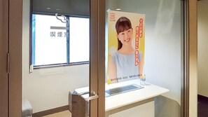 A hotel room with a window, a white desk, and a poster on the wall. - Daionji Onsen Banshokaku (Fukui)