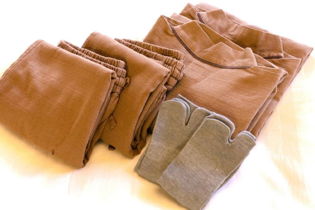 A stack of brown towels with gray cuffs.