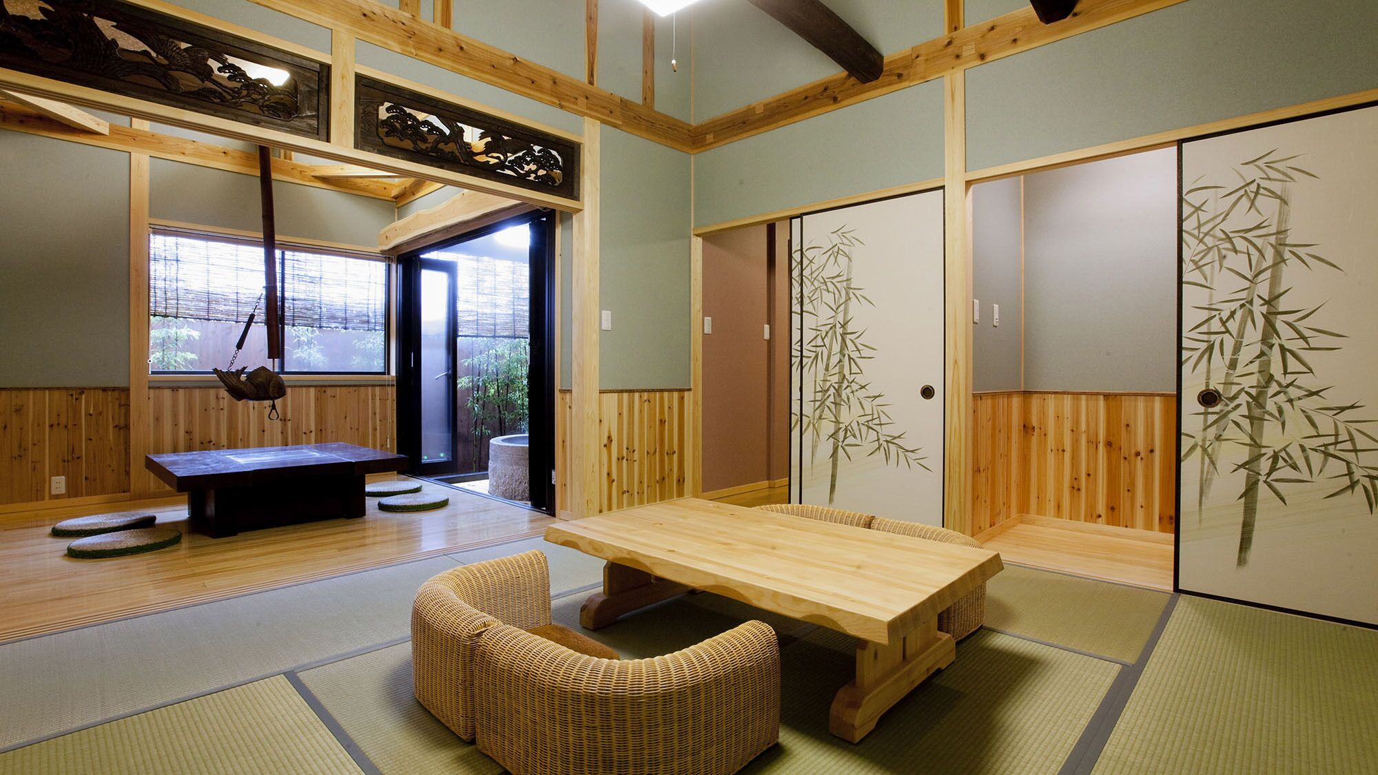A traditional Japanese room with tatami flooring, a low table, a cushioned bench, sliding doors with bamboo paintings, and a hanging lantern.