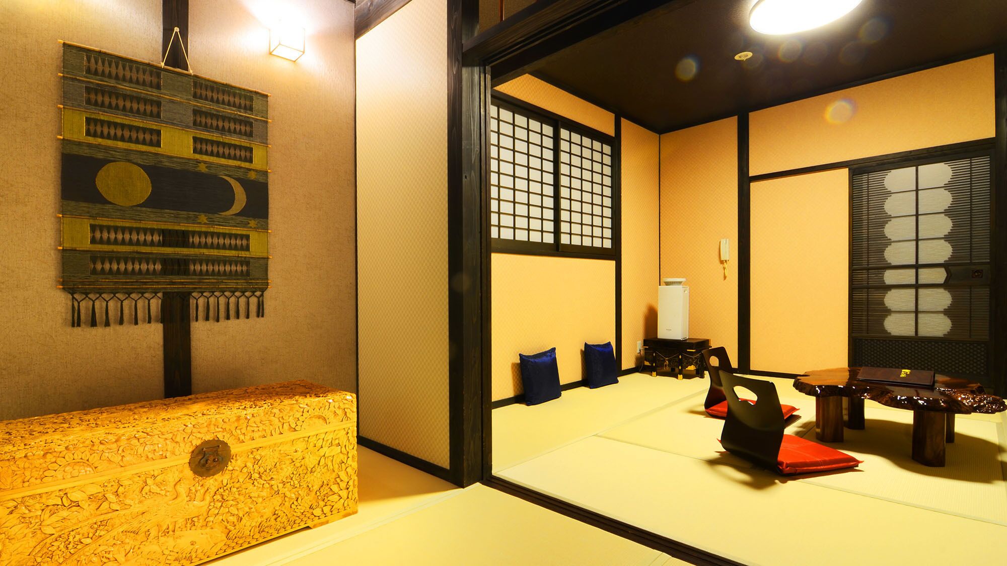 A traditional Japanese room with tatami flooring, a low wooden table, and a shoji screen.