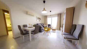 Apartment, 1 Bedroom | Living room | Flat-screen TV