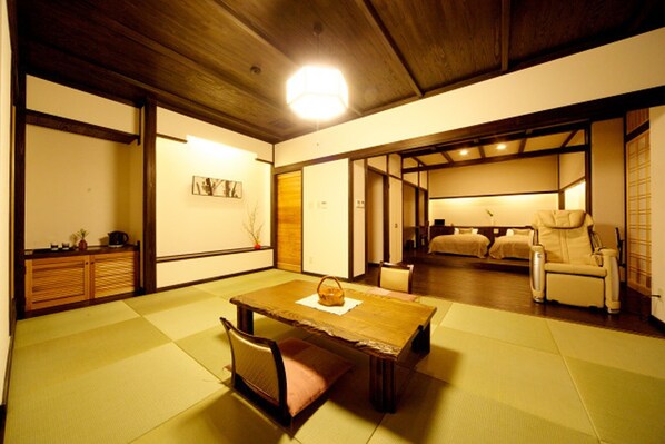A traditional Japanese room with tatami flooring, a low wooden table, a cushioned bench, and a sofa. - Iya Bijin (Miyoshi)