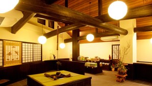 A traditional Japanese interior with tatami flooring, wooden beams, and a reception desk. - Iya Bijin (Miyoshi)