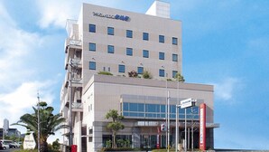 A multi-story hotel with a modern design, featuring a prominent entrance with glass doors and a visible signboard. - Hotel Marine Palace Sanuki (Takamatsu)