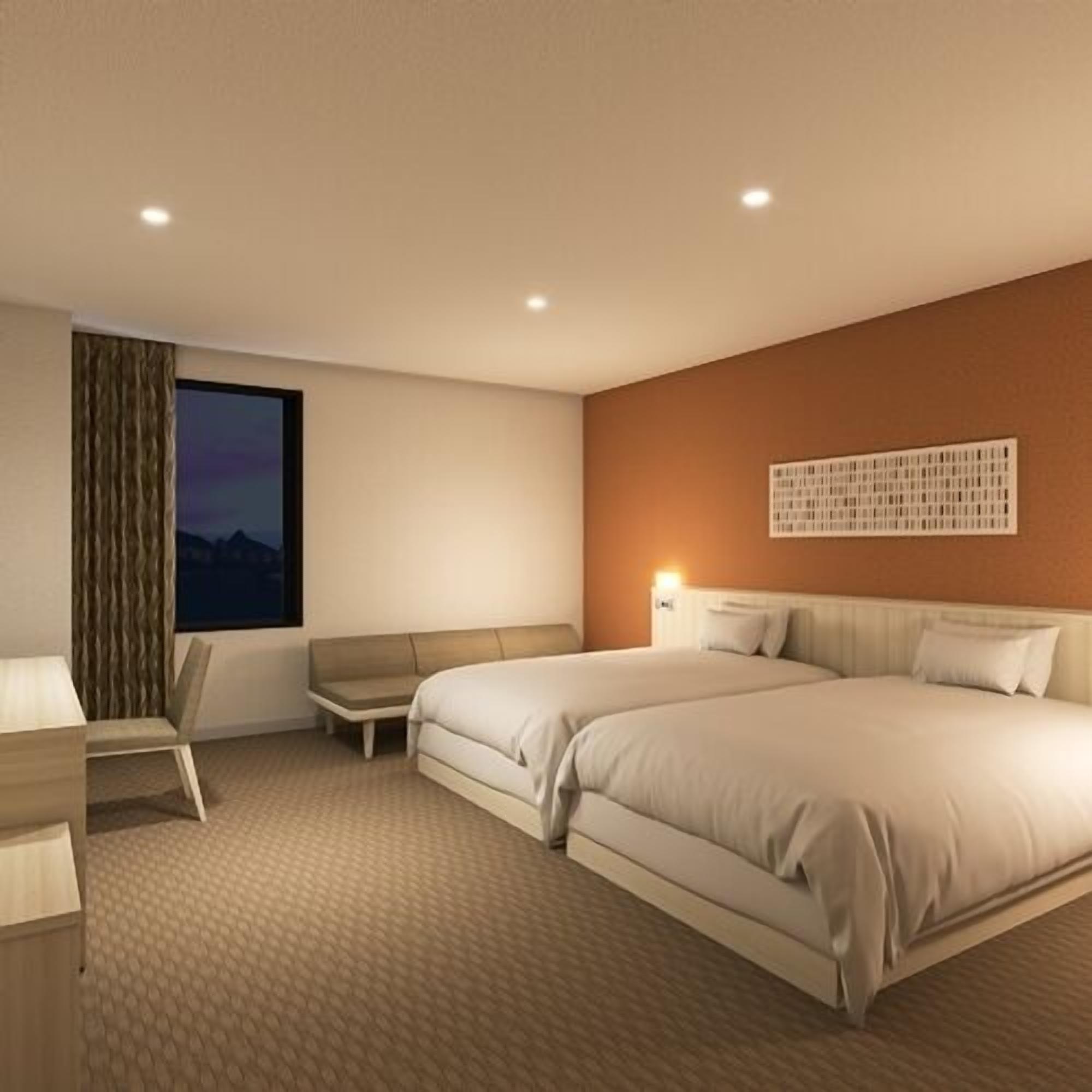 A modern hotel room with two beds, a desk, a chair, a window with a view, and a wall-mounted light fixture.