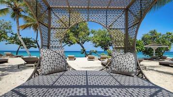 On the beach, beach cabanas, beach umbrellas, beach towels