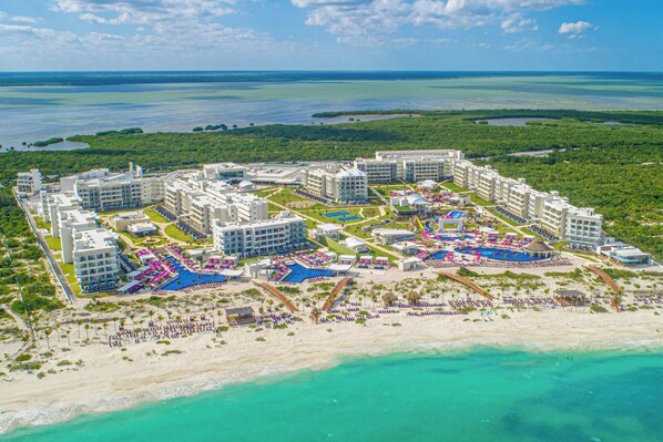 A resort with multiple buildings, a central pool area, and a beach. - Planet Hollywood Cancun by Royalton, An Autograph Collection All-Inclusive Resort (Costa Mujeres)