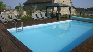 A swimming pool with lounge chairs and a gazebo. - 3 well equipped gites with swimming pool on the Loire Valley/Vienne border (Prinçay)
