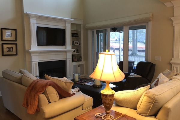 Open floor plan with new flat screen television and gas fireplace.