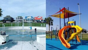 A water feature with a fountain and a playground with slides.