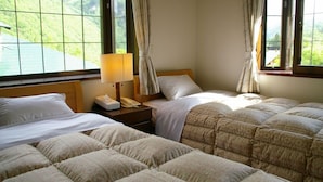 A hotel room with two beds, a bedside table with a lamp, a telephone, and a window with curtains. - Shinhotaka Onsen Resort In Chirorian (Takayama)