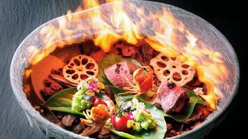 A bowl with food items and a fire burning above it.