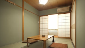 A traditional Japanese room with tatami flooring, a low wooden table, and sliding shoji doors. - Gero Onsen Kanko Hotel Yumotokan (Gero)