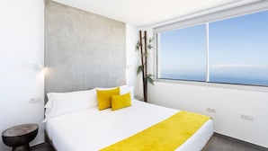 A modern bedroom with a large bed, white bedding, and a yellow throw. - 🌴☀️ Dream Vacation at Tulio Home Private Pool (Adeje)