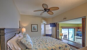 A bedroom with a bed, a ceiling fan, a window with blinds, and a view of the outside. - ★★★★★Spectacular Water View-Private Wrap-Around Balcony-3 Pools-2 Restaurants ☼☼ (St. Thomas)