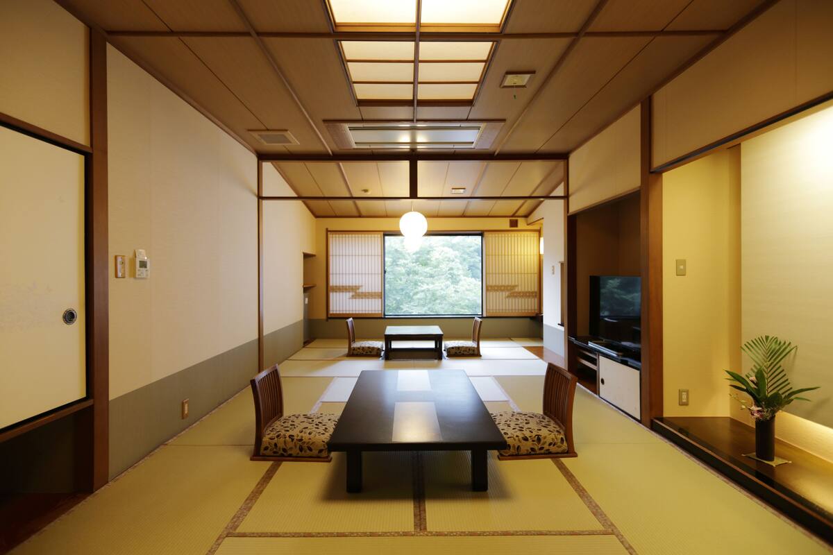 A traditional Japanese room with tatami flooring, a low table, and shoji screens.