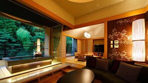 A modern living room with a wooden bench, a sofa, and a TV. - Hakone Kamon (Hakone)