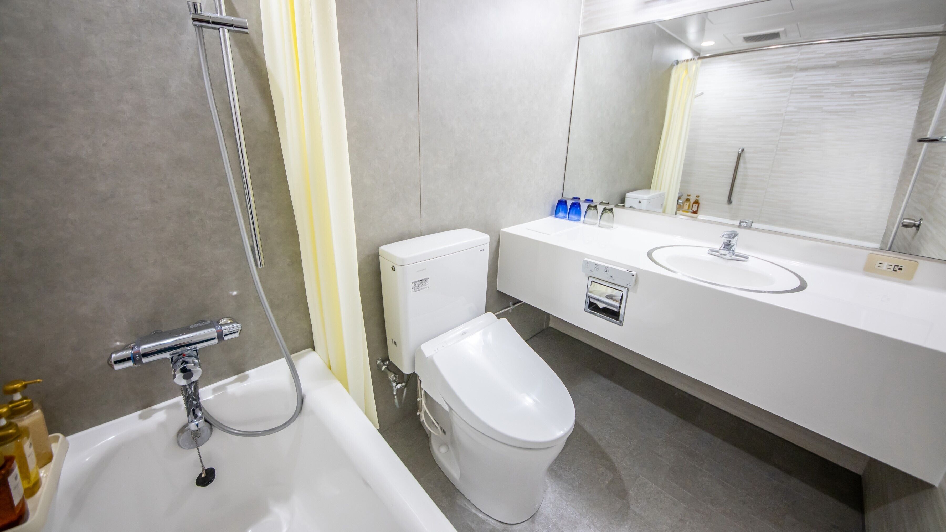 A modern bathroom with a bathtub, toilet, and sink.