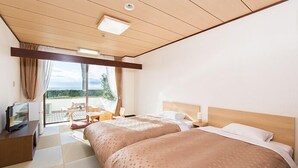 A hotel room with two beds, a TV, a desk, and a view of the outdoors. - Kominato Miiri Onsen Hotel Green Plaza Kamogawa (Kamogawa)