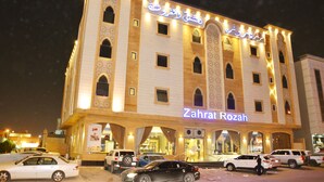 A hotel with a prominent sign reading "Zaharat Rozah" at night. - Zahrat Rozah (Riyadh)