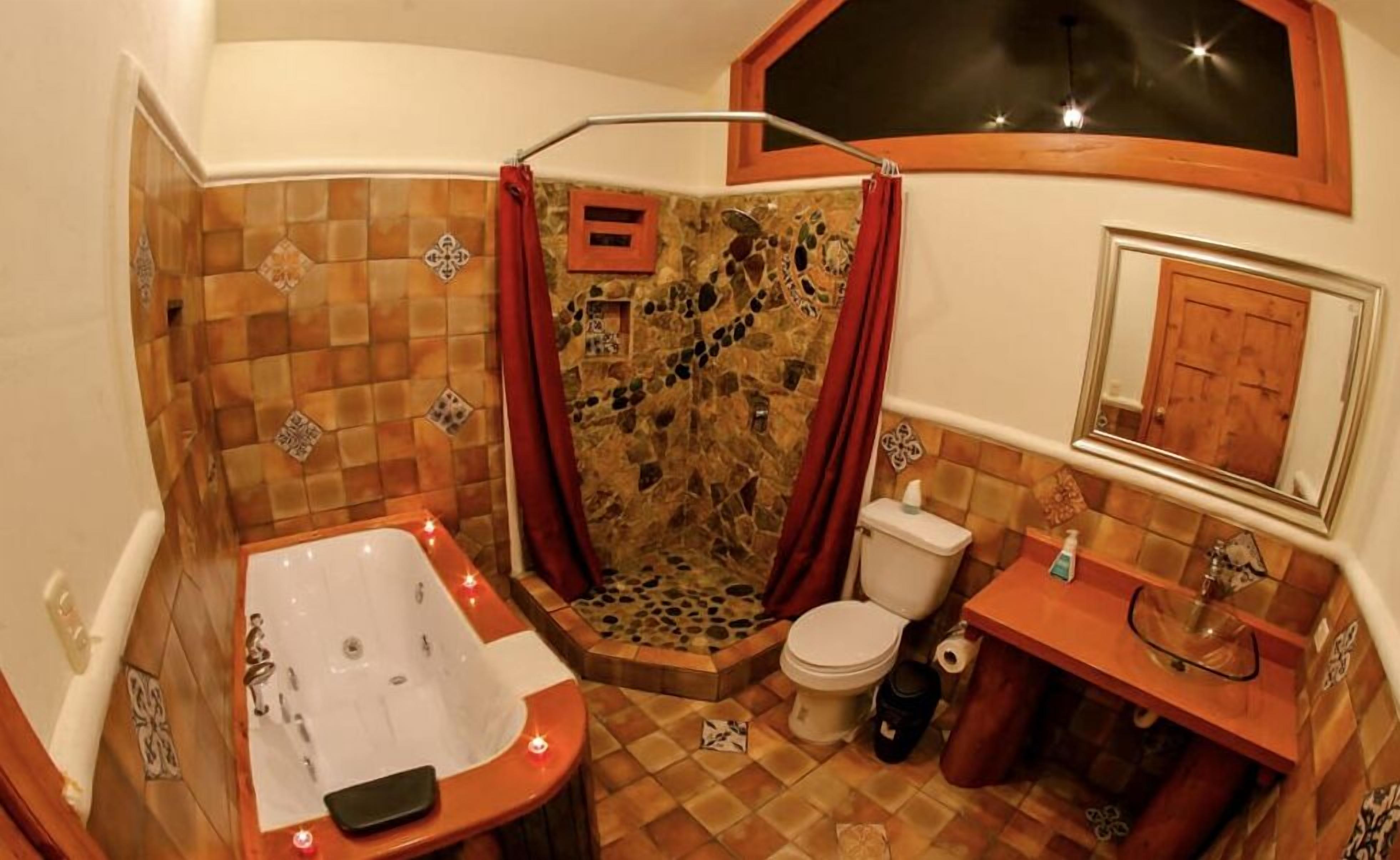 Un baño con ducha, inodoro y bañera.