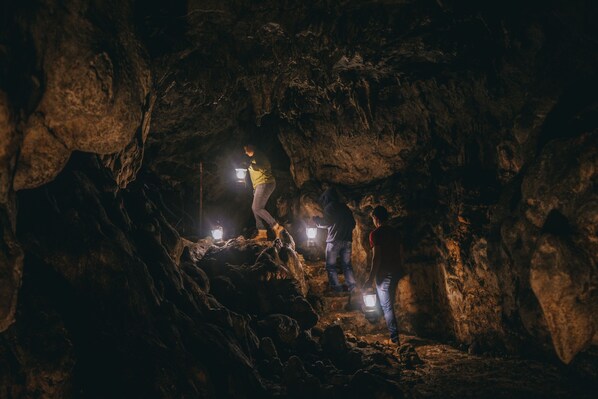 A cave with rough, uneven rock formations and a narrow passageway. - Country Delights Hotel (Purulha)