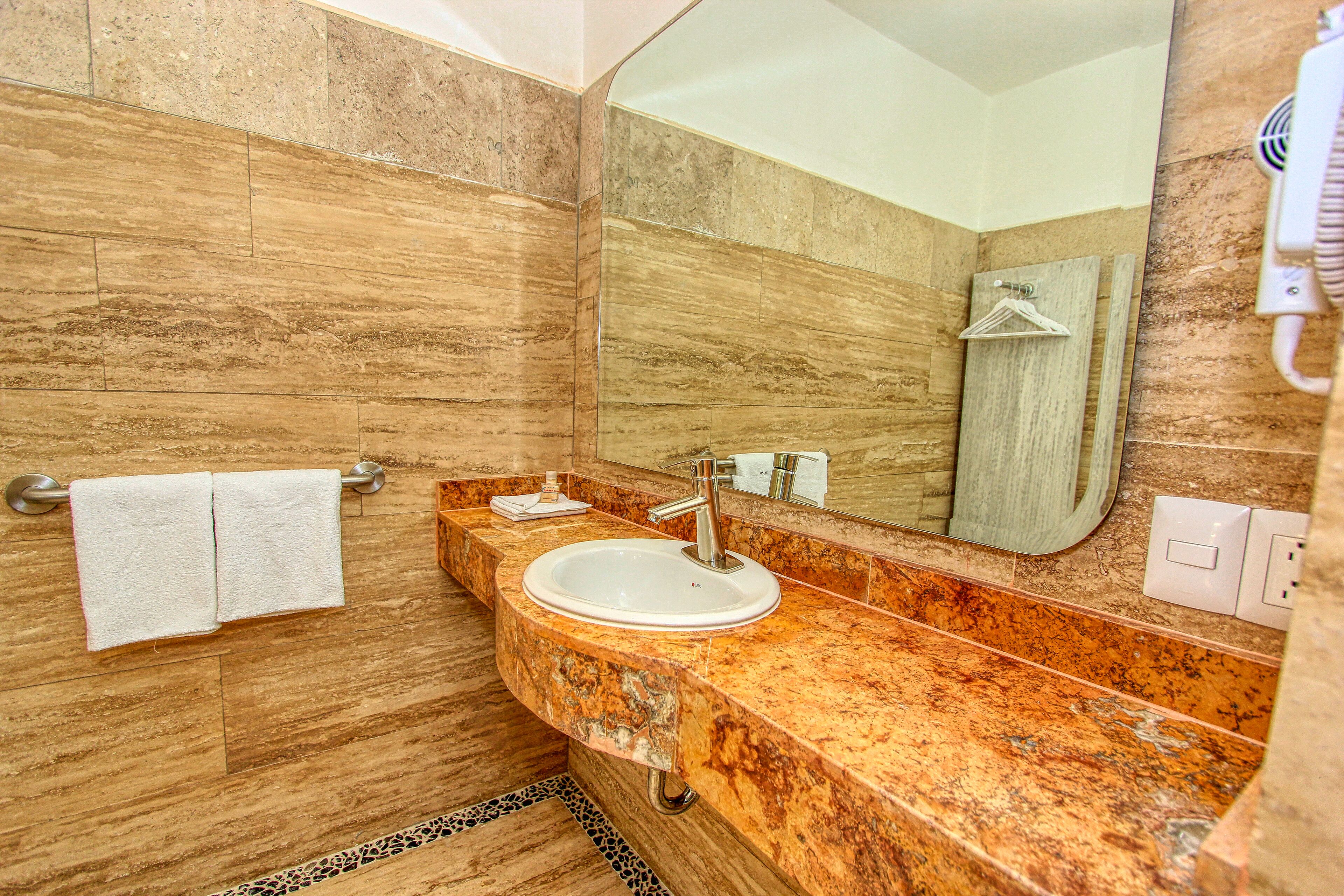 standard room, multiple beds | bathroom sink