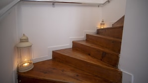 A wooden staircase with a handrail and a lantern on the left. - Mandalin Akyaka Hotel (Ula)