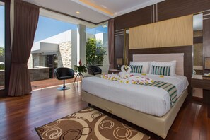 A modern hotel room with a large bed, a sitting area with a chair, a small table, and a view of the outdoors.