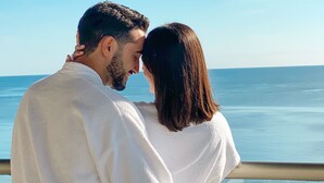 A couple standing by a railing overlooking a body of water. - Dreams Natura Resort & Spa - All Inclusive (Puerto Morelos)