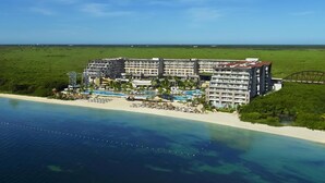 A resort with multiple buildings, a pool area, and a beach. - Dreams Natura Resort & Spa - All Inclusive (Puerto Morelos)