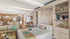 Ein Hotelzimmer mit Bett, Sofa, Essbereich und Bücherregal.