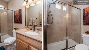A bathroom with a glass-enclosed shower, a sink with a vanity, and a toilet. - Separate Private Detached 1 Room Casita with your own entrance (Albuquerque)